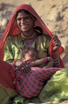 a portrait of a Rajasthani women with her Baby in the Town of Jaisalmer in the Province of Rajasthan in India.  India, Jaisalmer, January, 1998