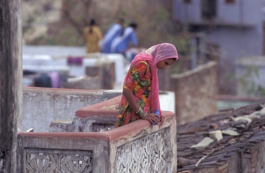 a Women stay at her Home and Balcony in the old Town at Jaisalmer Fort in city of Jaisalmer at  Province of Rajasthan in India.  India, Jaisalmer, January, 1998