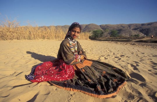 a portrait of a Rajasthani women in the Town of Jaisalmer in the Province of Rajasthan in India.  India, Jaisalmer, January, 1998