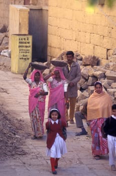 two Rajasthani women at a construction work in the Town of Jaisalmer in the Province of Rajasthan in India.  India, Jaisalmer, January, 1998