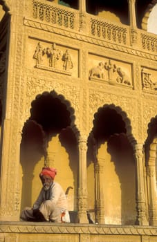 a men at the entry of the old Rangji Temple in the Town of Pushkar in the Province of Rajasthan in India.  India, Pushkar, January, 1998
