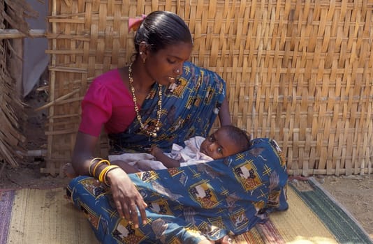 a portrait of a Rajasthani women with her Baby in the Town of Jaisalmer in the Province of Rajasthan in India.  India, Jaisalmer, January, 1998