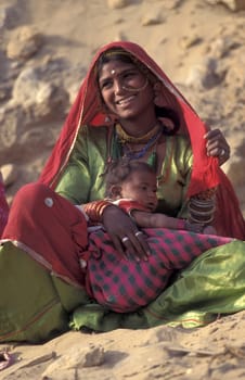 a portrait of a Rajasthani women with her Baby in the Town of Jaisalmer in the Province of Rajasthan in India.  India, Jaisalmer, January, 1998