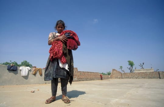 a women at her Laundry homework on a rooftop in the City of Jaisalmer in the Province of Rajasthan in India.  India, Jaisalmer January, 1998