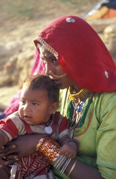 a portrait of a Rajasthani women with her Baby in the Town of Jaisalmer in the Province of Rajasthan in India.  India, Jaisalmer, January, 1998