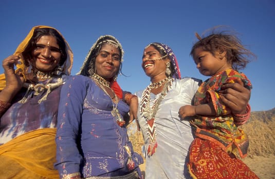 a portrait of a Rajasthani women with her Baby in the Town of Jaisalmer in the Province of Rajasthan in India.  India, Jaisalmer, January, 1998