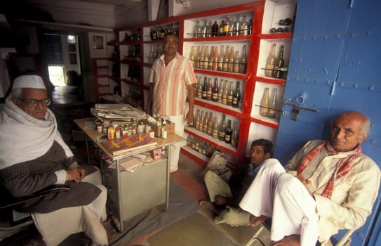 A Indian Doctor at his Drugstore and Madicine Shop at a market in the Town of Jaisalmer in the Province of Rajasthan in India.  India, Jaisalmer, January, 1998