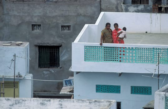 a Women stay at her Home and Balcony in the old Town at Jaisalmer Fort in city of Jaisalmer at  Province of Rajasthan in India.  India, Jaisalmer, January, 1998