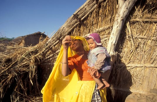 a portrait of a Rajasthani women with her Baby in the Town of Jaisalmer in the Province of Rajasthan in India.  India, Jaisalmer, January, 1998