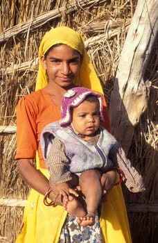a portrait of a Rajasthani women with her Baby in the Town of Jaisalmer in the Province of Rajasthan in India.  India, Jaisalmer, January, 1998