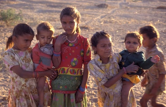 a group of Rajasthani children posing in the Town of Jaisalmer in the Province of Rajasthan in India.  India, Jaisalmer, January, 1998