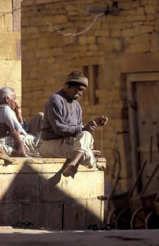 a men at spinning thread in alley in the Old Town of Jaisalmer in the Province of Rajasthan in India.  India, Jaisalmer, January, 1998