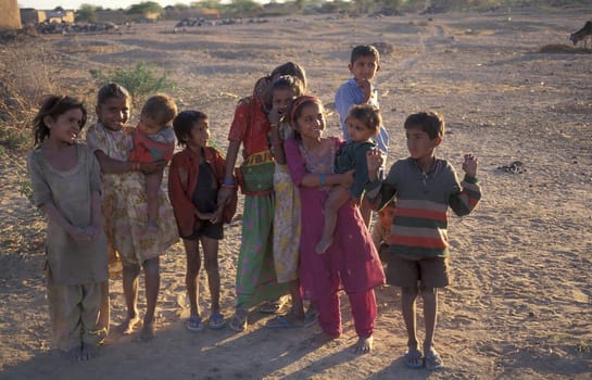 a group of Rajasthani children posing in the Town of Jaisalmer in the Province of Rajasthan in India.  India, Jaisalmer, January, 1998
