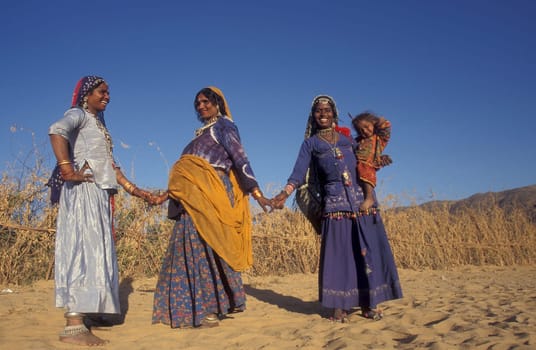 a portrait of a Rajasthani women with her Baby in the Town of Jaisalmer in the Province of Rajasthan in India.  India, Jaisalmer, January, 1998