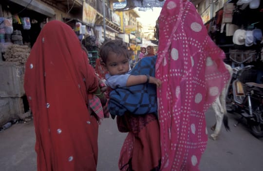 a Rajasthani women with her Baby in the Town of Jaisalmer in the Province of Rajasthan in India.  India, Jaisalmer, January, 1998