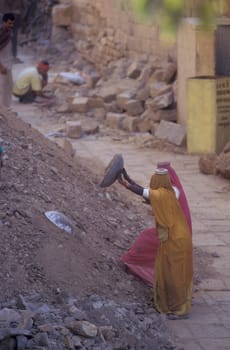 two Rajasthani women at a construction work in the Town of Jaisalmer in the Province of Rajasthan in India.  India, Jaisalmer, January, 1998