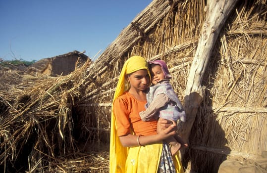 a portrait of a Rajasthani women with her Baby in the Town of Jaisalmer in the Province of Rajasthan in India.  India, Jaisalmer, January, 1998