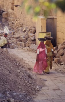 two Rajasthani women at a construction work in the Town of Jaisalmer in the Province of Rajasthan in India.  India, Jaisalmer, January, 1998