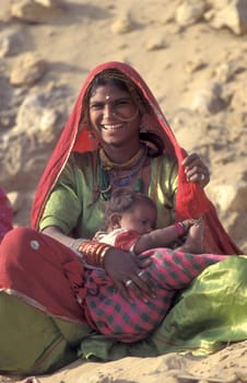 a portrait of a Rajasthani women with her Baby in the Town of Jaisalmer in the Province of Rajasthan in India.  India, Jaisalmer, January, 1998