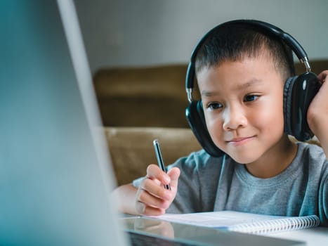 Online education, Technology studying at home using laptop computer, Student distance learning virtual distance online class on video call virtual lesson, Teaching child boy with remote education.