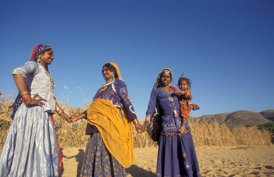 a portrait of a Rajasthani women with her Baby in the Town of Jaisalmer in the Province of Rajasthan in India.  India, Jaisalmer, January, 1998