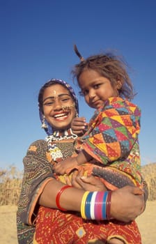 a portrait of a Rajasthani women with her Baby in the Town of Jaisalmer in the Province of Rajasthan in India.  India, Jaisalmer, January, 1998