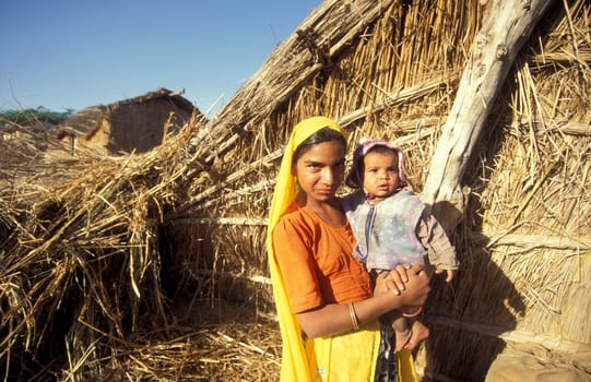 ortrait of a Rajasthani women with her Baby in the Town of Jaisalmer in the Province of Rajasthan in India.  India, Jaisalmer, January, 1998