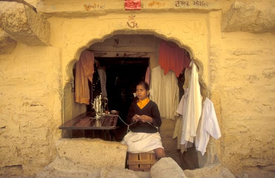 a young Rajasthani women at a Tailor shop in the Town of Jaisalmer in the Province of Rajasthan in India.  India, Jaisalmer, January, 1998
