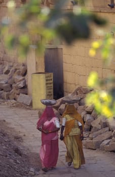 two Rajasthani women at a construction work in the Town of Jaisalmer in the Province of Rajasthan in India.  India, Jaisalmer, January, 1998