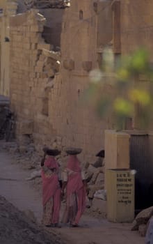 two Rajasthani women at a construction work in the Town of Jaisalmer in the Province of Rajasthan in India.  India, Jaisalmer, January, 1998