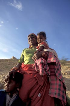 a portrait of a Rajasthani women with her Baby in the Town of Jaisalmer in the Province of Rajasthan in India.  India, Jaisalmer, January, 1998