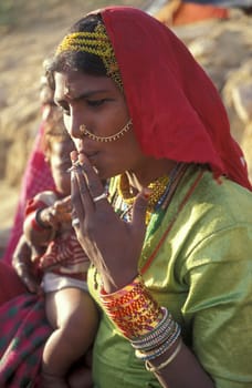 a portrait of a Rajasthani women in the Town of Jaisalmer in the Province of Rajasthan in India.  India, Jaisalmer, January, 1998