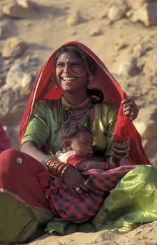 a portrait of a Rajasthani women with her Baby in the Town of Jaisalmer in the Province of Rajasthan in India.  India, Jaisalmer, January, 1998