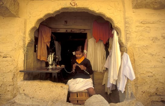 a young Rajasthani women at a Tailor shop in the Town of Jaisalmer in the Province of Rajasthan in India.  India, Jaisalmer, January, 1998