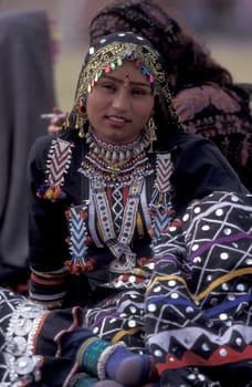 Women in traditional Rajasthani dress at the Bikaner Camel Festival in the Town of Bikaner in the Province of Rajasthan in India.  India, Bikaner, January, 1998
