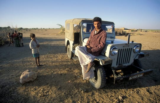 a Rajasthani Men with his Car in a small Village near the Town of Bikaner in the Province of Rajasthan in India.  India, Bikaner, January, 1998