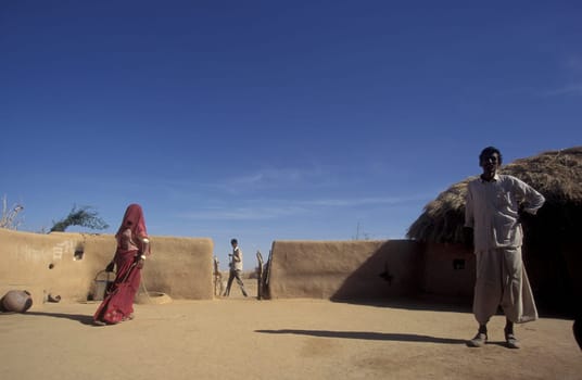 a Rajasthani Family in their Home in a small Village near the Town of Bikaner in the Province of Rajasthan in India.  India, Bikaner, January, 1998