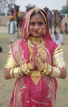 Women in traditional Rajasthani dress at the Bikaner Camel Festival in the Town of Bikaner in the Province of Rajasthan in India.  India, Bikaner, January, 1998