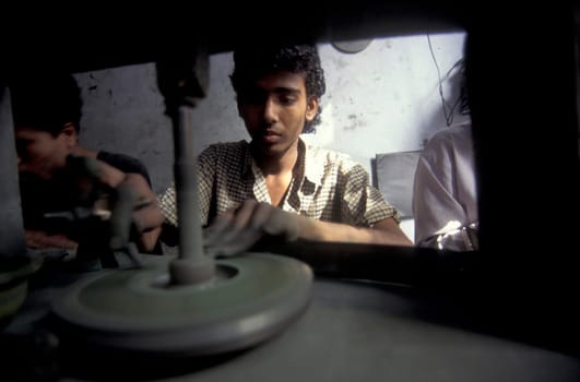 Working People in a Factory of gemstone cutting in the City of Jaipur in the Province of Rajasthan in India.  India, JAIPUR, January, 1998