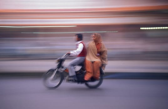 a Motorbike  traffic on a road in the City of Jaipur in the Province of Rajasthan in India.  India, Jaipur, January, 1998