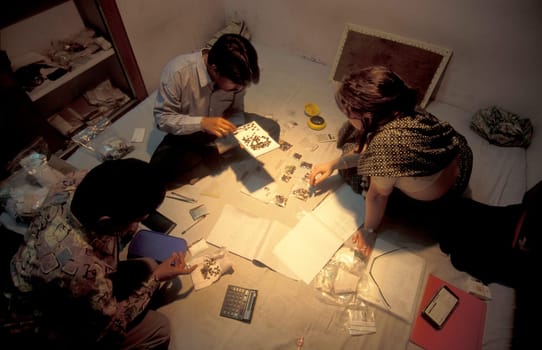 Working People in a Factory of gemstone cutting in the City of Jaipur in the Province of Rajasthan in India.  India, JAIPUR, January, 1998