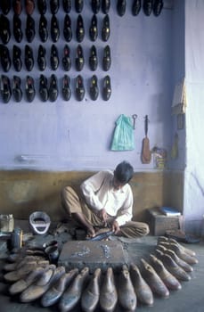a Shoe maker in a shoe Factory in the City of Jaipur in the Province of Rajasthan in India.  India, JAIPUR, January, 1998