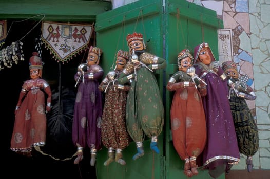a indian Kitputli Dance Puppet figures shop in the City of Jaipur in the Province of Rajasthan in India.  India, Jaipur, January, 1998