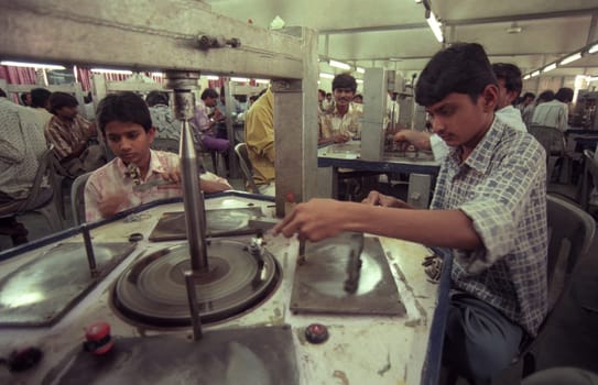 Working People in a Factory of gemstone cutting in the City of Jaipur in the Province of Rajasthan in India.  India, JAIPUR, January, 1998