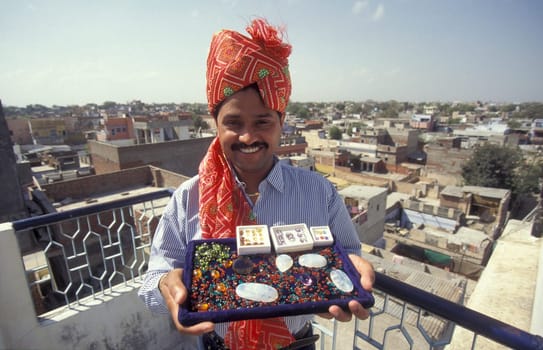The Boss of a  Gemstone Trading company and Factory of gemstone cutting in the City of Jaipur in the Province of Rajasthan in India.  India, JAIPUR, January, 1998