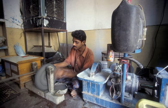 Working People in a Factory of gemstone cutting in the City of Jaipur in the Province of Rajasthan in India.  India, JAIPUR, January, 1998