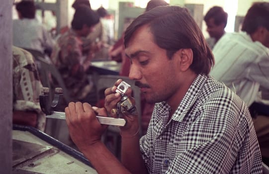 Working People in a Factory of gemstone cutting in the City of Jaipur in the Province of Rajasthan in India.  India, JAIPUR, January, 1998