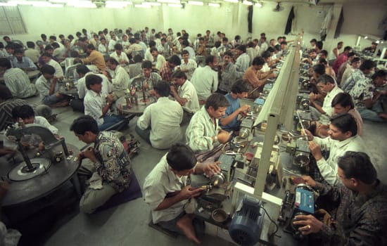 Working People in a Factory of gemstone cutting in the City of Jaipur in the Province of Rajasthan in India.  India, JAIPUR, January, 1998