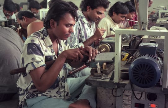 Working People in a Factory of gemstone cutting in the City of Jaipur in the Province of Rajasthan in India.  India, JAIPUR, January, 1998