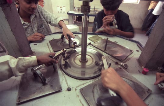 Working People in a Factory of gemstone cutting in the City of Jaipur in the Province of Rajasthan in India.  India, JAIPUR, January, 1998